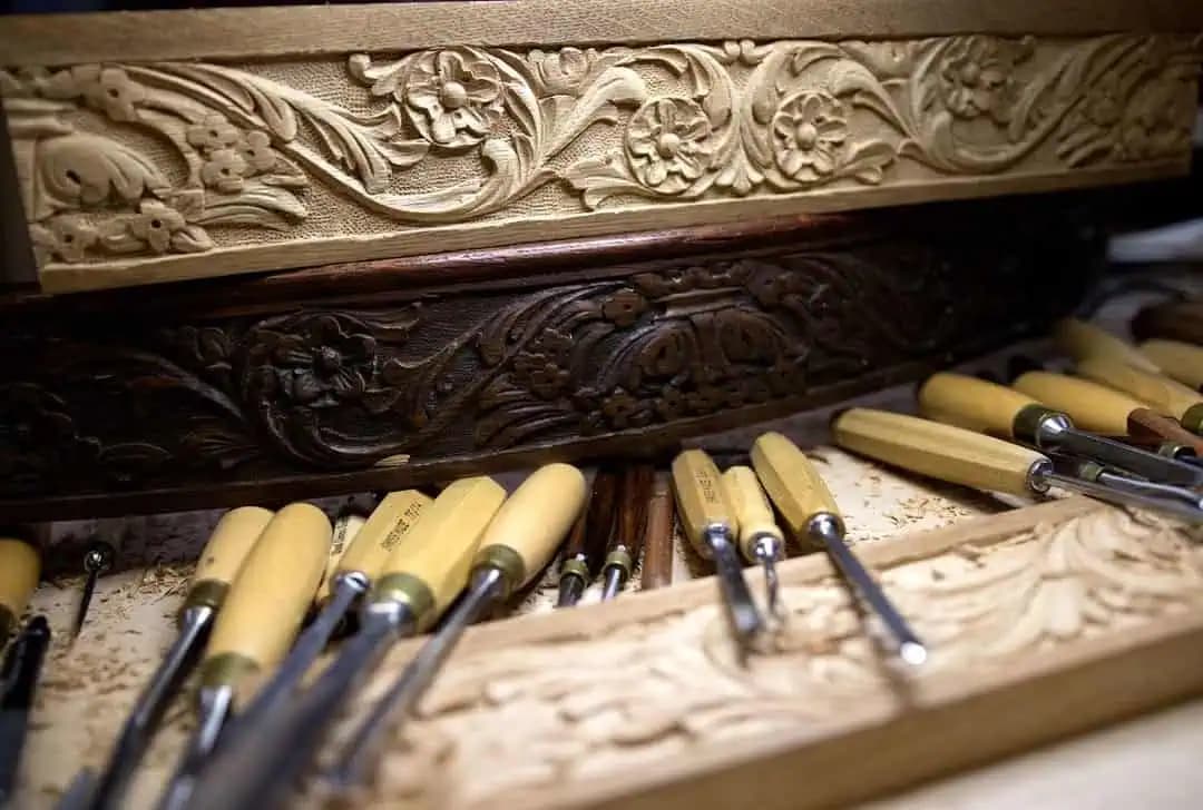 Carved Floral Scroll Frieze Moldings Floral scroll moldings beside carving gouges, custom wood carving by Alexander Grabovetskiy in his studio.