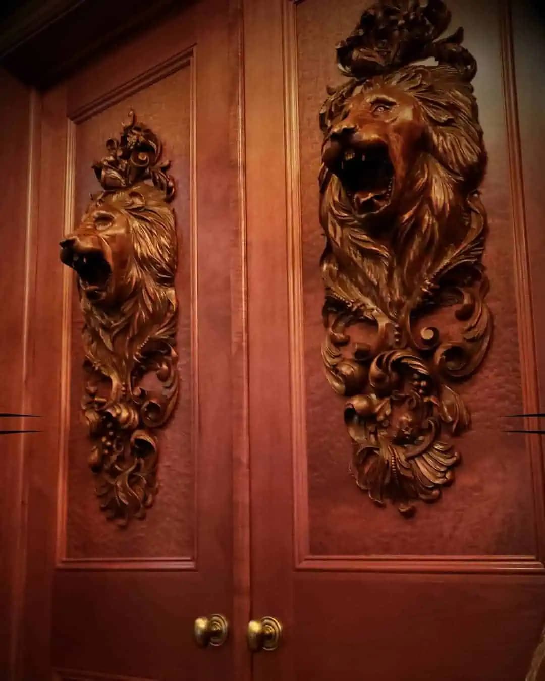 Carved Lion Head Door Panels Pair of carved lion-head door panels by Alexander Grabovetskiy, a custom wood carving mounted on paneled doors.