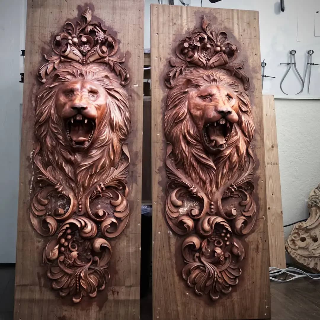 Carved Lion Head Panels with Acanthus Scrolls Pair of carved roaring lion head panels by Alexander Grabovetskiy, a custom wood carving in progress.