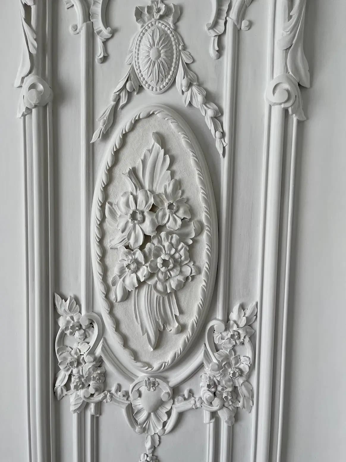 Carved Floral Oval Wall Panel Architectural wall panel with floral oval medallion, custom wood carving by Alexander Grabovetskiy, painted white.