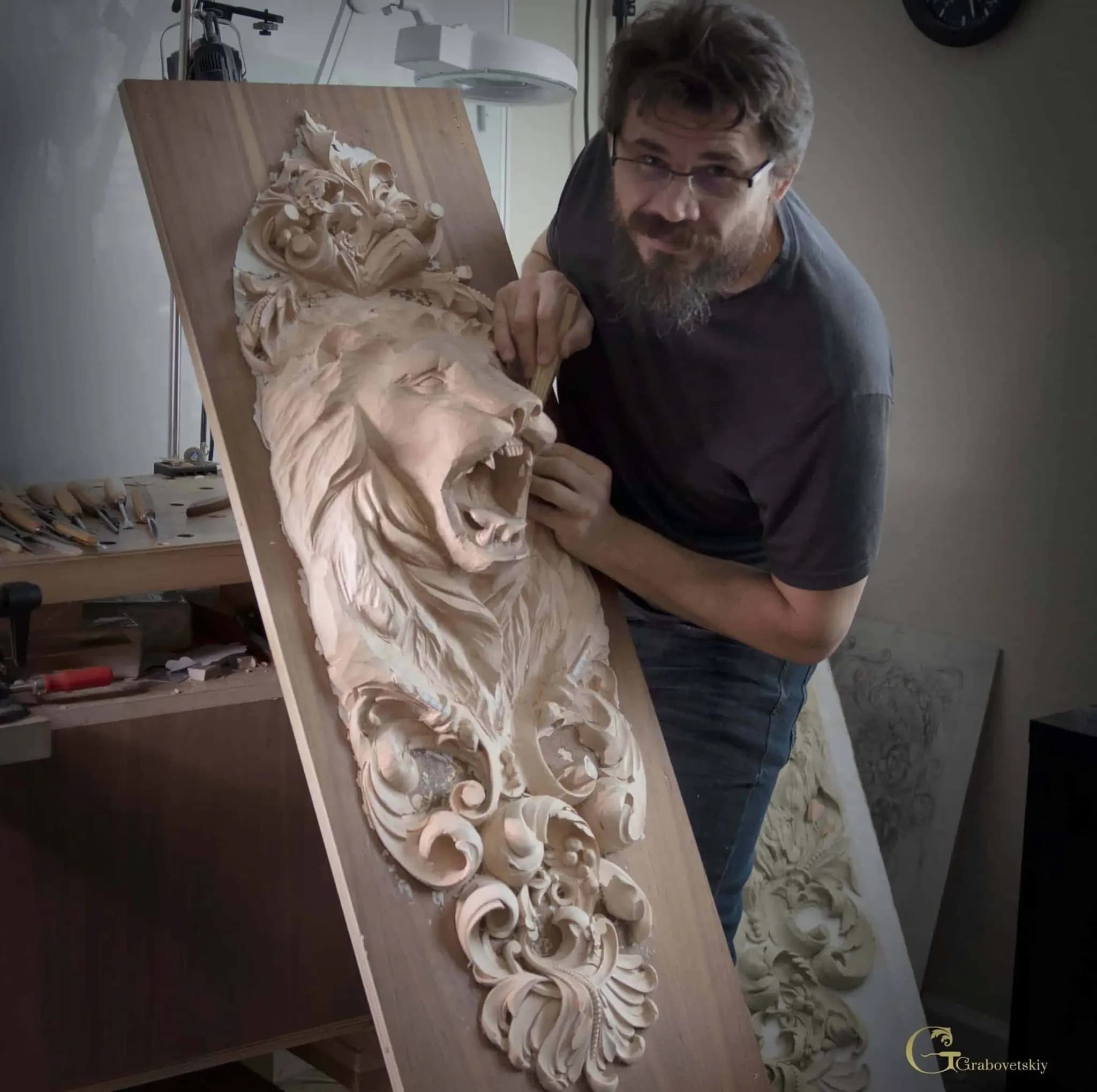 Roaring Lion Relief Carving Panel Alexander Grabovetskiy carving a roaring lion head limewood panel, a custom wood carving in progress in his studio.