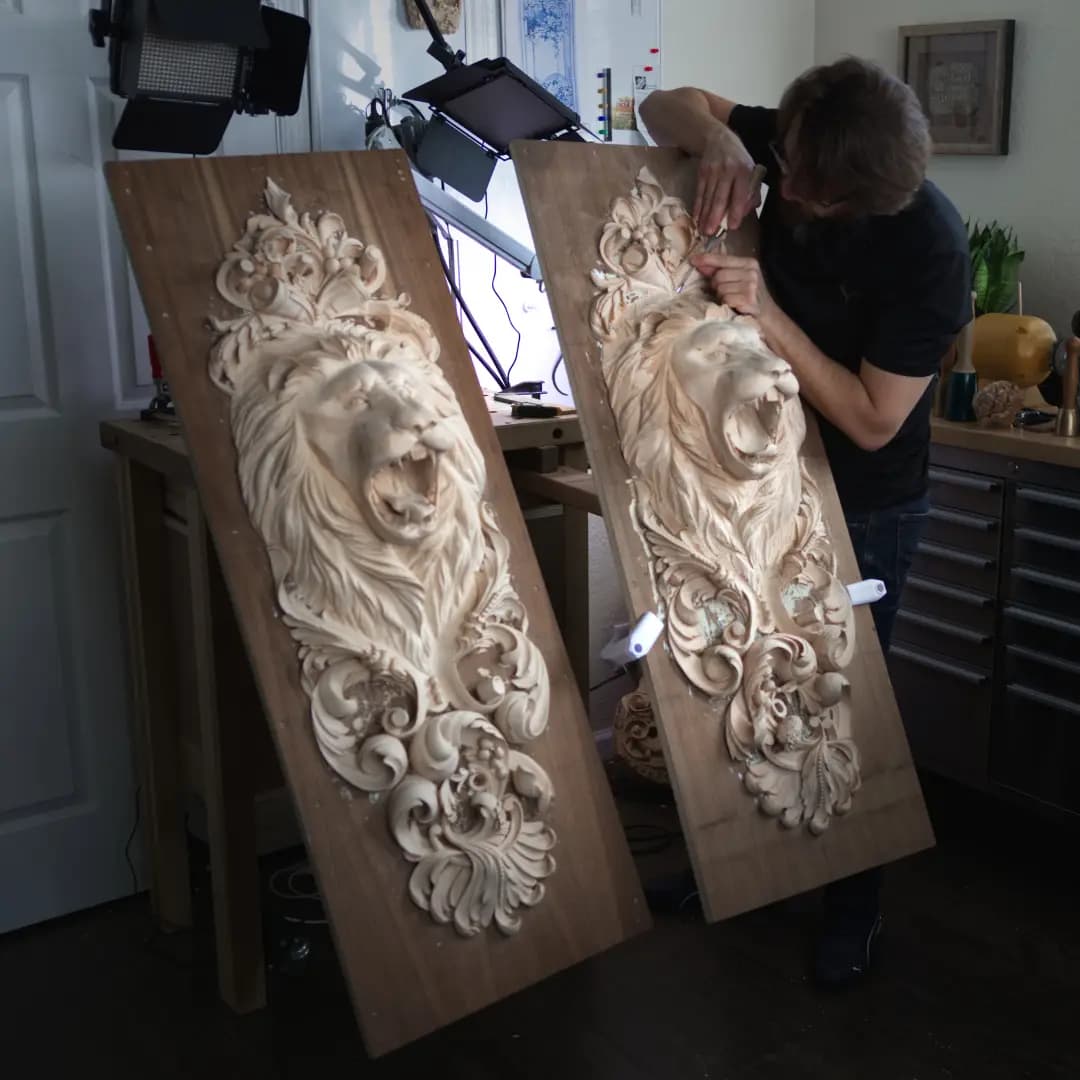 Carved Lion Head Pilaster Panels Alexander Grabovetskiy carving a roaring lion head limewood panel in his studio, a commission wood carving in progress.