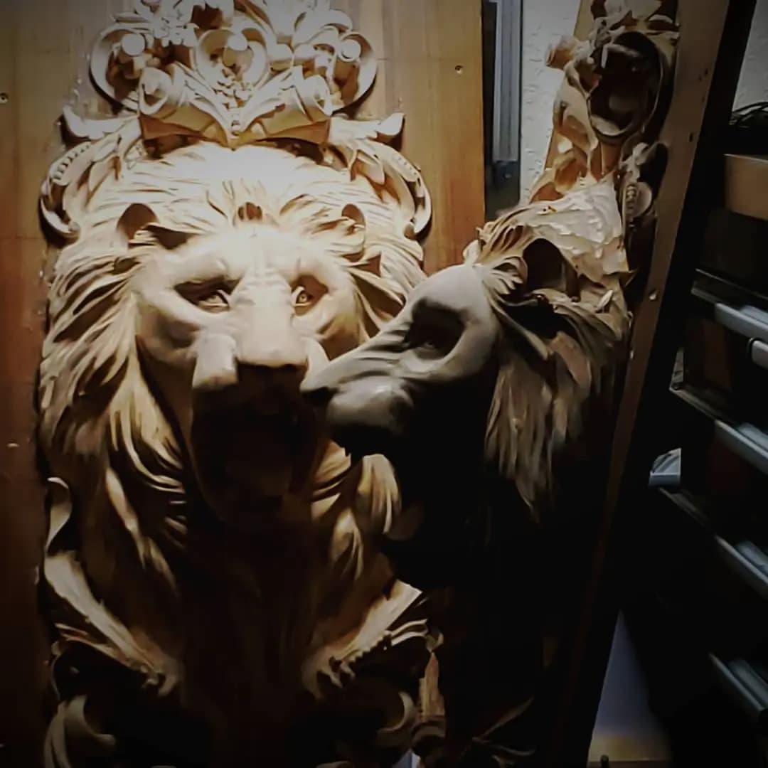 Crowned Lion Head Sculptural Carving Limewood lion head with crown and flowing mane carved by Alexander Grabovetskiy as a custom wood carving.