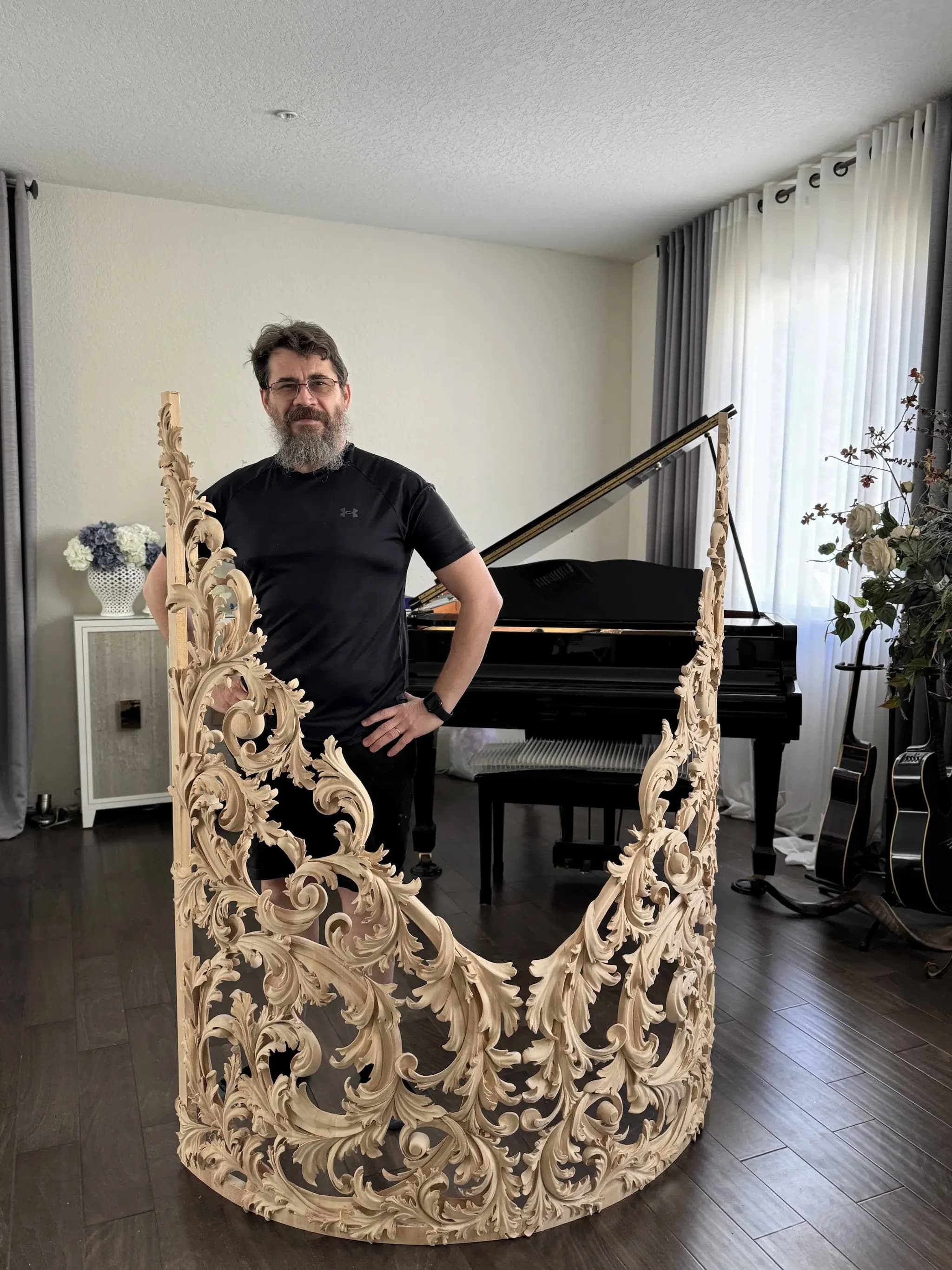 Curved Baroque Acanthus Organ Shade Alexander Grabovetskiy stands beside a curved limewood organ shade, a custom wood carving of pierced acanthus scrolls.
