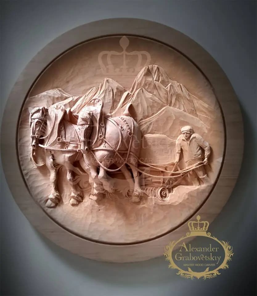 Plowing Team with Draft Horses Roundel Round limewood relief of a farmer plowing with two draft horses below mountains, custom wood carving by Alexander Grabovetskiy.