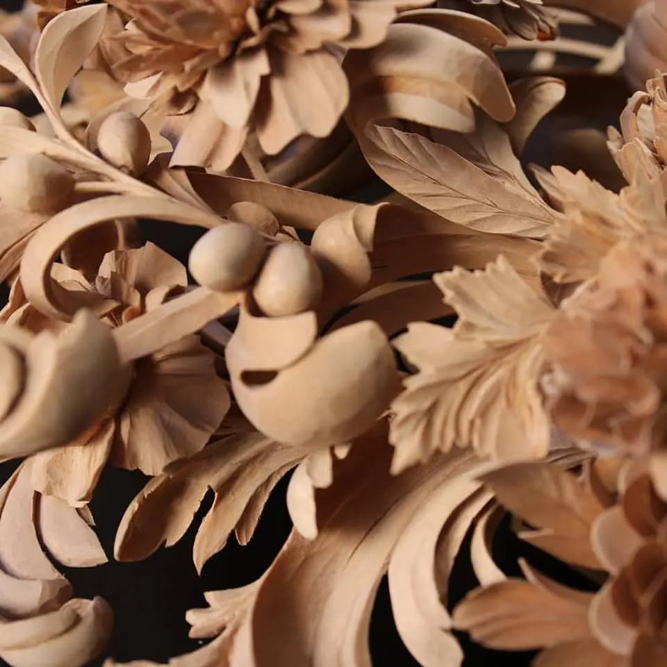 Deep-Relief Carved Chrysanthemums and Foliage Deeply carved limewood chrysanthemums, berries, and leaves by Alexander Grabovetskiy, a custom wood carving detail.