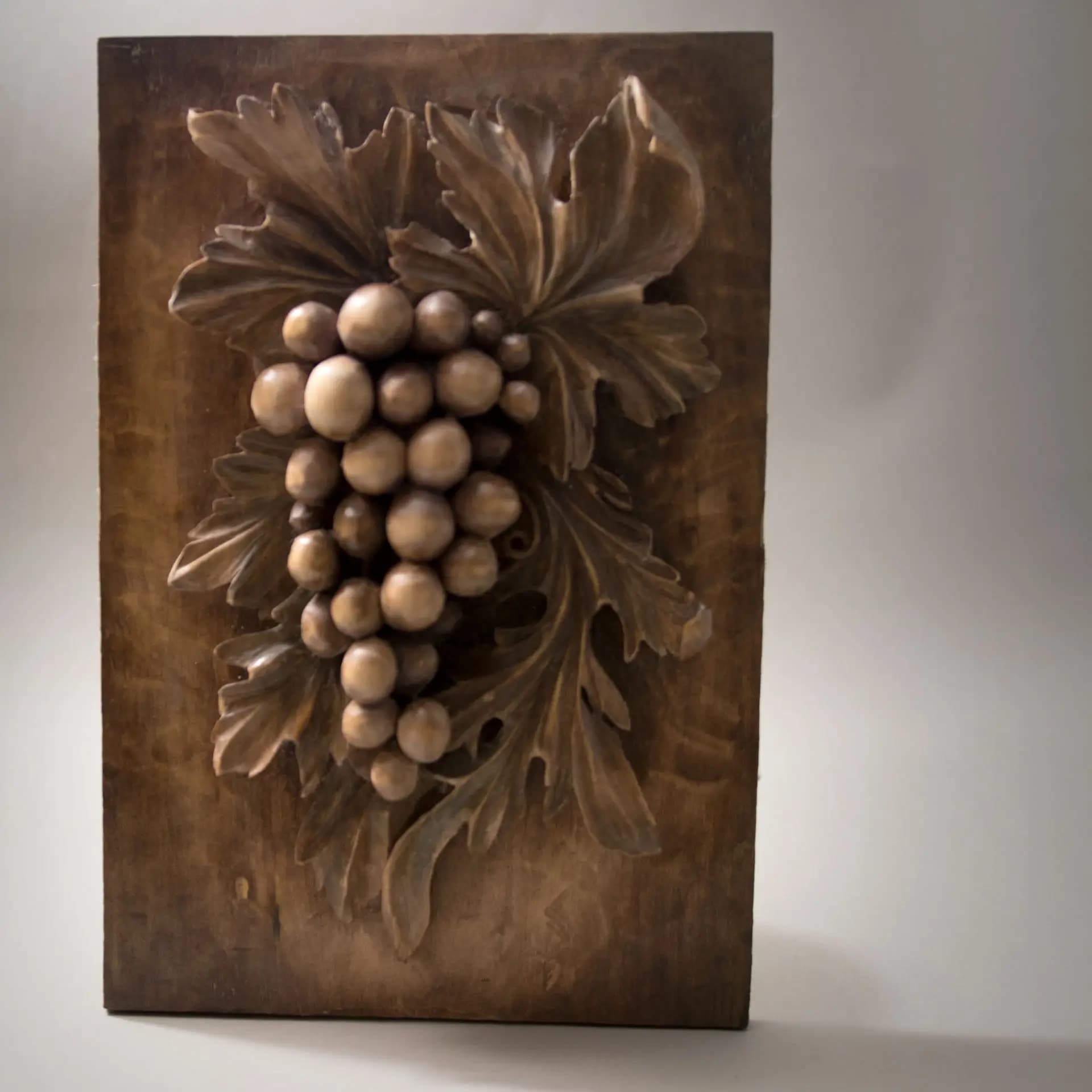 Carved Grape Cluster Relief Panel Deep relief grape cluster and vine leaves, a custom wood carving by Alexander Grabovetskiy in limewood.